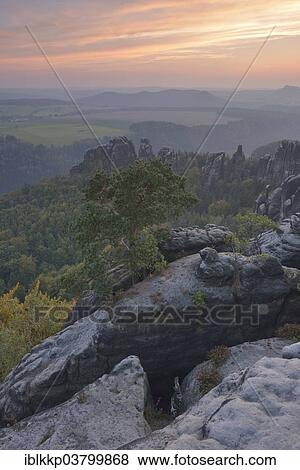 "View over the Schrammsteine ​​in the Elbe Sandstone Mountains at dusk in autumn, Saxon Switzerland, Bad Schandau, Saxony, Germany, Europe" View Large Photo Image Stock Photo - "View over the Schrammsteine ​​in the Elbe Sandstone Mountains at dusk in autumn, Saxon Switzerland, Bad Schandau, Saxony, Germany, Europe". Fotosearch