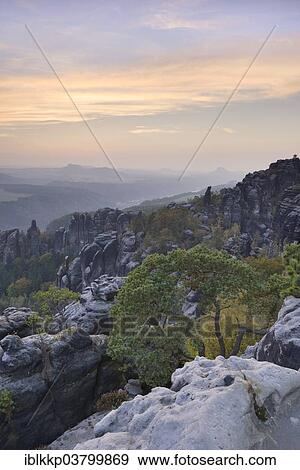 Stock Photo - "View over the Schrammsteine â€‹â€‹in the Elbe Sandstone Mountains at dusk in autumn, Saxon Switzerland, Bad Schandau, Saxony, Germany, Europe". Fotosearch