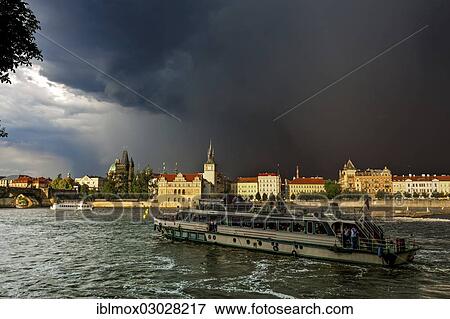 Stock Photo - "View over the Vltava river towards a thunderstorm, Bedrich Smetana Museum at the rear, Charles Bridge, former waterworks, Old Town Bridge Tower and Water Tower, Mala Strana, Prague, Czech Republic, Europe". Fotosearch