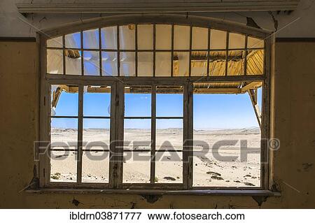 "View through a window of an abandoned house in a former diamond miners settlement that is slowly covered by the sand of the Namib Desert, Kolmanskop, ÇKaras, Namibia, Africa" View Large Photo Image Stock Photo - "View through a window of an abandoned house in a former diamond miners settlement that is slowly covered by the sand of the Namib Desert, Kolmanskop, ÇKaras, Namibia, Africa". Fotosearch