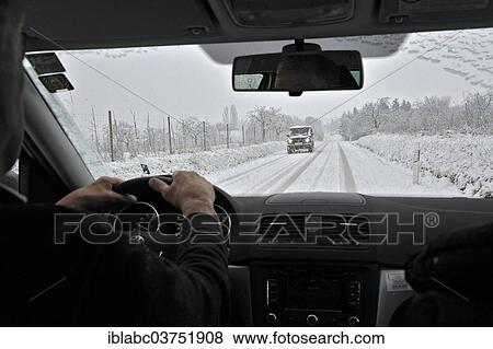 "View through the windscreen during snowfall, snow-covered country road, Georgenborn, Schlangenbad, Hesse, Germany, Europe" View Large Photo Image Stock Photo - "View through the windscreen during snowfall, snow-covered country road, Georgenborn, Schlangenbad, Hesse, Germany, Europe". Fotosearch