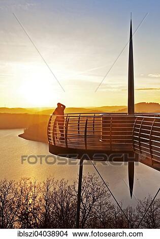 "Viewing platform Biggeblick with a person at sunset, Biggesee reservoir, Attendorn, Sauerland, North Rhine-Westphalia, Germany, Europe" View Large Photo Image Picture - "Viewing platform Biggeblick with a person at sunset, Biggesee reservoir, Attendorn, Sauerland, North Rhine-Westphalia, Germany, Europe". Fotosearch