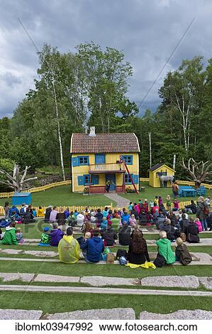Stock Image - "Villa Villekulla, viewers watching a scene from the children's book """"Pippi Longstocking"""" by children's author Astrid Lindgren, Astrid Lindgren's World World theme park, Vimmerby, Smaland, Sweden, Europe". Fotosearch