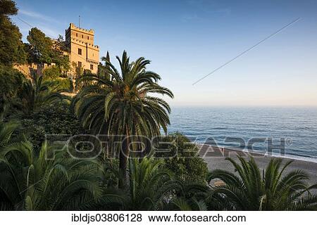 Stock Photo - "Villa with palm trees by the sea, Finale Ligure, Riviera di Ponente, Liguria, Italy, Europe". Fotosearch