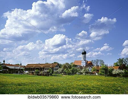 Stock Image - "Village view with the parish church of St. Emmeram, Kleinhelfendorf, Aying, Upper Bavaria, Bavaria, Germany, Europe". Fotosearch