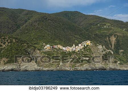 Stock Photo - "Village with colorful houses by the sea, Corniglia, Cinque Terre, UNESCO World Heritage Site, Province of La Spezia, Liguria, Italy, Europe". Fotosearch