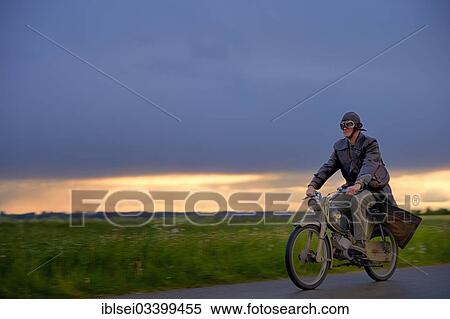 "Vintage motorcyclist in front of a dramatic cloudy sky, Mindelheim, Unterallgau District, Bavaria, Germany, Europe" View Large Photo Image Stock Photography - "Vintage motorcyclist in front of a dramatic cloudy sky, Mindelheim, Unterallgau District, Bavaria, Germany, Europe". Fotosearch