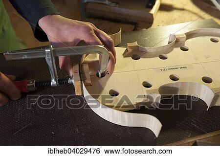 "Violin making, attaching the wooden tun ring" View Large Photo Image Stock Photograph - "Violin making, attaching the wooden tun ring". Fotosearch