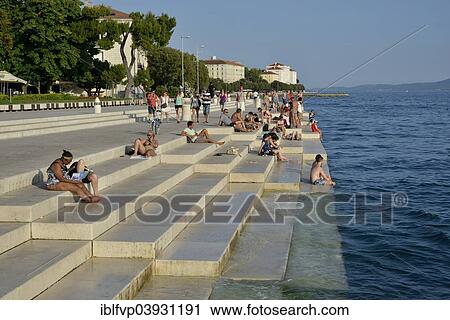 "Visitors basking in the evening sun at the Sea Organ by architect Nikola Basic, Zadar, Dalmatia, Croatia, Europe" View Large Photo Image Stock Image - "Visitors basking in the evening sun at the Sea Organ by architect Nikola Basic, Zadar, Dalmatia, Croatia, Europe". Fotosearch