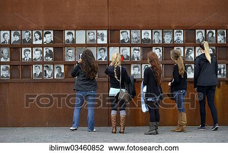 Stock Image - "Visitors in front of photos of victims of the Berlin Wall, Berlin Wall Memorial, Berlin, Berlin, Germany, Europe". Fotosearch