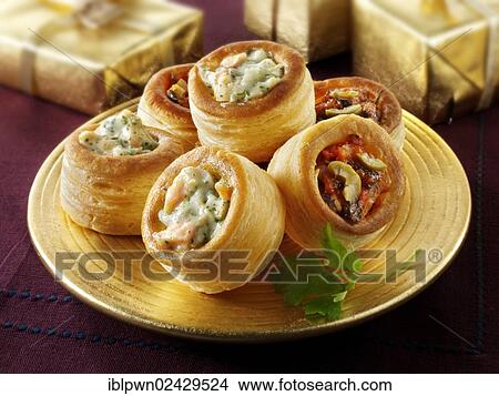 Vol-au-vents filled with salmon and dill cream and olive tapenade on a gold plate with gold presents View Large Photo Image Picture - Vol-au-vents filled with salmon and dill cream and olive tapenade on a gold plate with gold presents. Fotosearch