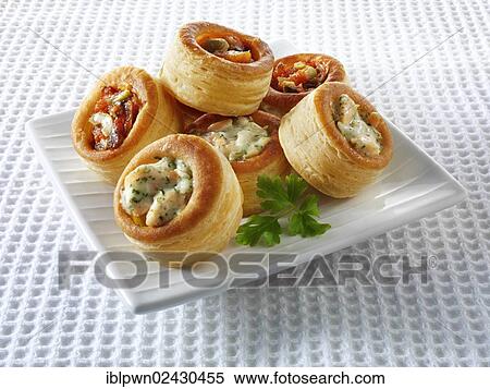Stock Photography - "Vol-au-vents, made from puff pastry filled with salmon, dill cream and olive tapenade". Fotosearch