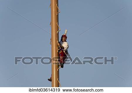 Stock Photo - "Volador climbed the palo volador mast, at a village festival, San Miguel, Cuetzalan, Puebla, Mexico, North America". Fotosearch