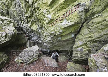 Stock Image - "Volcanic vent, conveyor tube of basalt, with lettering """"Teufelskeller"""", German for """"Devil's Basement"""", Rhon Biosphere Reserve, UNESCO biosphere reserve, Oberelsbach, Bavaria, Germany, Europe". Fotosearch
