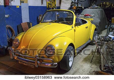 Stock Image - "VW Beetle Cabrio, yellow, in a garage, Beirut, Lebanon, Asia". Fotosearch