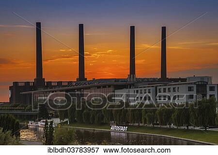 "VW KonzernForum premises with the entrance to the Autostadt complex and the heating station of the Volkswagen plant with its four chimneys, Wolfsburg, Lower Saxony, Germany, Europe" View Large Photo Image Stock Photo - "VW KonzernForum premises with the entrance to the Autostadt complex and the heating station of the Volkswagen plant with its four chimneys, Wolfsburg, Lower Saxony, Germany, Europe". Fotosearch
