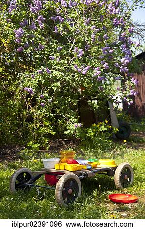 Stock Photograph - "Wagon with toys, sand moulds, garden, Saxony, Germany, Europe". Fotosearch