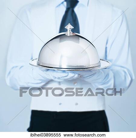 Stock Photography - Waiter holding a cloche. Fotosearch
