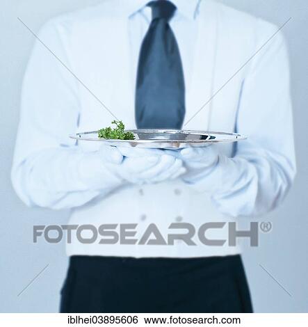 Stock Photograph - Waiter holding a silver tray. Fotosearch