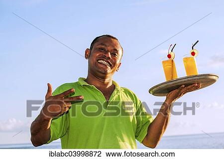 "Waiter serving drinks, Wakatobi Dive Resort, Sulawesi, Indonesia, Asia" View Large Photo Image Stock Image - "Waiter serving drinks, Wakatobi Dive Resort, Sulawesi, Indonesia, Asia". Fotosearch