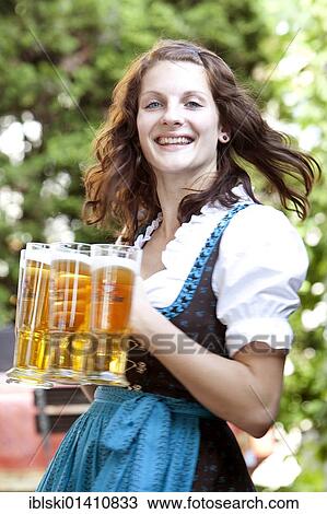 "Waitress in a dirndl, beer glasses, in a Bavarian beer garden, Regensburg, Bavaria, Germany, Europe" View Large Photo Image Stock Image - "Waitress in a dirndl, beer glasses, in a Bavarian beer garden, Regensburg, Bavaria, Germany, Europe". Fotosearch