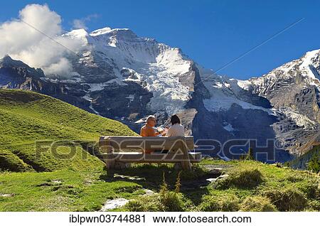 Stock Image - "Walkers having a rest, Grindelwald First, Swiss Alps, Grindelwald, Canton of Bern, Switzerland, Europe". Fotosearch