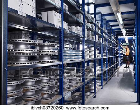 "Warehouseman working in the spare parts storage section of a car repair shop, St. Gertraudi, Reith im Alpbachtal, Kufstein District, North Tirol, Tirol, Austria, Europe" View Large Photo Image Stock Image - "Warehouseman working in the spare parts storage section of a car repair shop, St. Gertraudi, Reith im Alpbachtal, Kufstein District, North Tirol, Tirol, Austria, Europe". Fotosearch