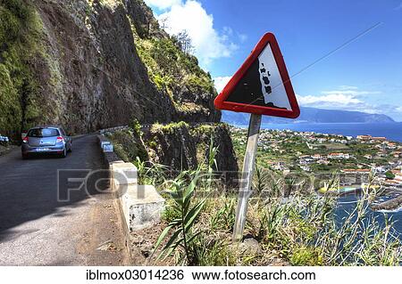 Stock Photograph - "Warning sign, falling rocks, on road along the cliffs at Ponta Delgada, Vicente, Boaventura, Madeira, Portugal, Europe". Fotosearch