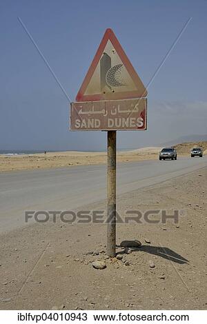 "Warning sign warns of sand dunes, near Mirbat, Dhofar Region, Oman, Asia" View Large Photo Image Stock Image - "Warning sign warns of sand dunes, near Mirbat, Dhofar Region, Oman, Asia". Fotosearch