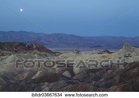 "Wasteland of Gower Gulch with Manly Beacon crag, right, Death Valley and Panamint Mountains at the rear, at dawn with a full moon, Zabriskie Point, Death Valley National Park, California, United States, North America" View Large Photo Image Picture - "Wasteland of Gower Gulch with Manly Beacon crag, right, Death Valley and Panamint Mountains at the rear, at dawn with a full moon, Zabriskie Point, Death Valley National Park, California, United States, North America". Fotosearch
