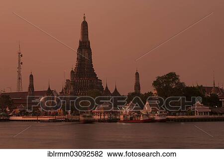 Stock Image - "Wat Arun or """"Temple of Dawn"""" on the Chao Phraya River at sunrise, Thonburi, Bangkok, Bangkok, Thailand, Asia". Fotosearch