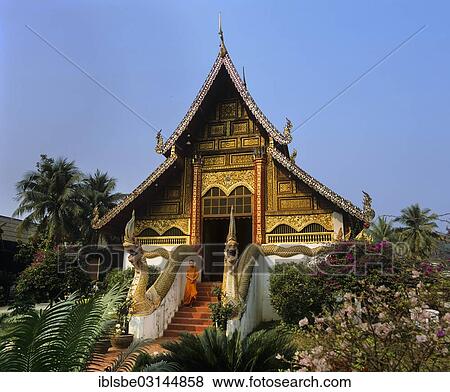 Stock Photo - "Wat Phra Kaew Temple, monk on the stairs, Chiang Rai, Chiang Rai Province, Northern Thailand, Thailand, Asia". Fotosearch