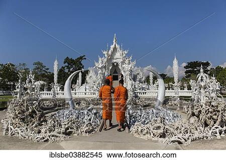 Stock Photography - "Wat Rong Khun, depiction of hell, monks on the steps to the entrance of the White Temple, by architect Chalermchai Kositpipat, Chiang Rai, Chiang Rai Province, Northern Thailand, Thailand, Asia". Fotosearch