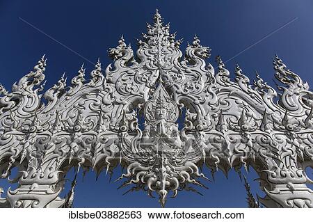 Stock Image - "Wat Rong Khun, detail of the ornate bridge of the White Temple by the architect and artist Chalermchai Kositpipat, Chiang Rai, Chiang Rai Province, Northern Thailand, Thailand, Asia". Fotosearch