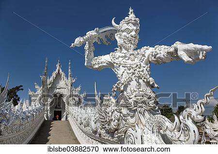 "Wat Rong Khun, ornate guardian and demon on the bridge of the White Temple by architect and artist Chalermchai Kositpipat, Chiang Rai, Chiang Rai Province, Northern Thailand, Thailand, Asia" View Large Photo Image Stock Image - "Wat Rong Khun, ornate guardian and demon on the bridge of the White Temple by architect and artist Chalermchai Kositpipat, Chiang Rai, Chiang Rai Province, Northern Thailand, Thailand, Asia". Fotosearch