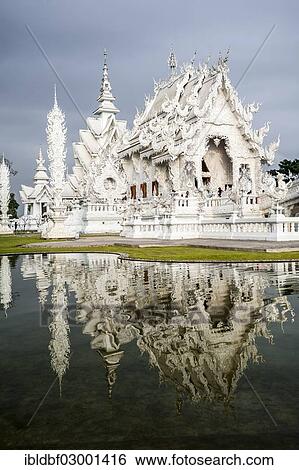 Stock Photograph - "Wat Rong Khun temple or The White Wat with reflection, a Buddhist-Hindu temple by architect Chalermchai Kositpipat, Chiang Rai, Chiang Rai Province, Northern Thailand, Thailand, Asia". Fotosearch