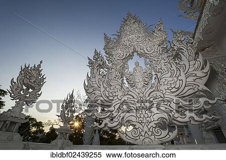 Stock Photography - "Wat Rong Khun Temple or White Temple, a Buddhist-Hindu temple, detailed view, backlit, Chiang Rai, northern Thailand, Thailand, Asia". Fotosearch