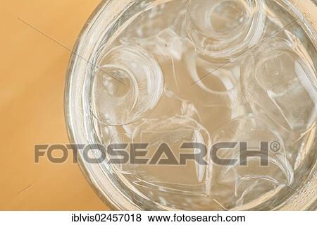 Water chilled with ice cubes in a glass View Large Photo Image Stock Photo - Water chilled with ice cubes in a glass. Fotosearch