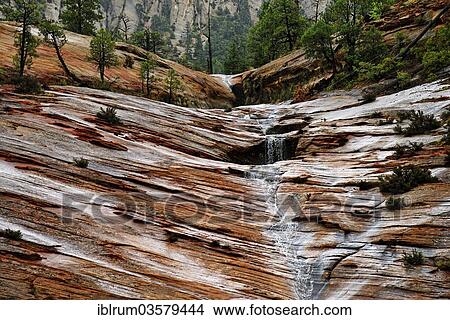 Picture - "Water draining off over red Navajo sandstone rocks after a rainstorm near Canyon Overlook, Zion National Park, Utah, United States, North America". Fotosearch