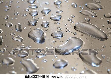 Water droplets on a metal surface View Large Photo Image Stock Photograph - Water droplets on a metal surface. Fotosearch