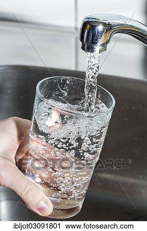 Water flowing from a tap into a glass View Large Photo Image Stock Image - Water flowing from a tap into a glass. Fotosearch