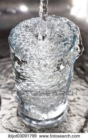 Water overflowing in a glass View Large Photo Image Stock Photo - Water overflowing in a glass. Fotosearch