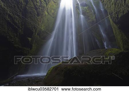 Stock Image - "Waterfall, 50m, cascading into a ravine overgrown by moss, Porsmerkurvegur, Iceland, Europe". Fotosearch