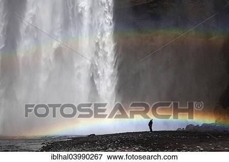 Stock Photo - "Waterfall with a rainbow, Skogafoss, Iceland, Europe". Fotosearch