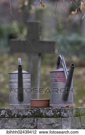 "Watering cans on a cemetery, Weimar, Thuringia, Germany, Europe" View Large Photo Image Stock Image - "Watering cans on a cemetery, Weimar, Thuringia, Germany, Europe". Fotosearch