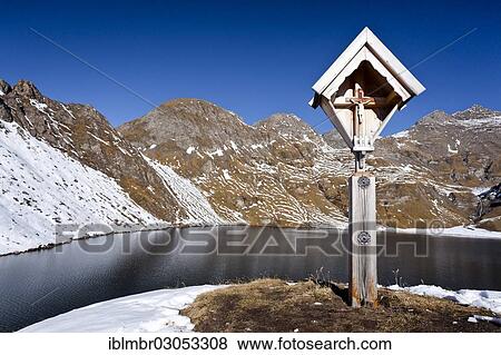 "Wayside cross at Wilder See Lake, peaks of Mt Wilde Kreuzspitze at back, Pfunderer Berge, Alpen, South Tyrol province, Trentino-Alto Adige, Italy, Europe" View Large Photo Image Stock Photo - "Wayside cross at Wilder See Lake, peaks of Mt Wilde Kreuzspitze at back, Pfunderer Berge, Alpen, South Tyrol province, Trentino-Alto Adige, Italy, Europe". Fotosearch