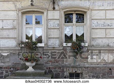"Weathered facade with relics of a former grocery store, faded inscription, Wandlitz-Zerpenschleuse, Brandenburg, Germany, Europe" View Large Photo Image Stock Photograph - "Weathered facade with relics of a former grocery store, faded inscription, Wandlitz-Zerpenschleuse, Brandenburg, Germany, Europe". Fotosearch