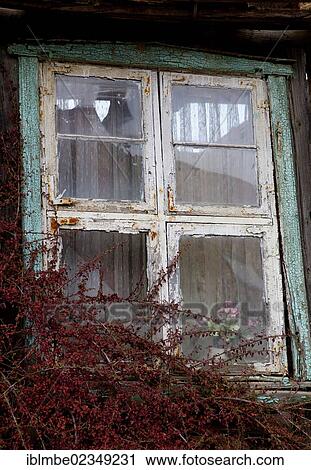 Stock Image - "Weathered window on an old unoccupied farmhouse in Gruenefeld, Havelland region, Brandenburg, Germany, Europe". Fotosearch