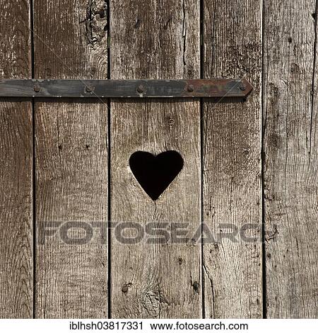 "Weathered wooden door with a heart, outside toilet" View Large Photo Image Stock Image - "Weathered wooden door with a heart, outside toilet". Fotosearch