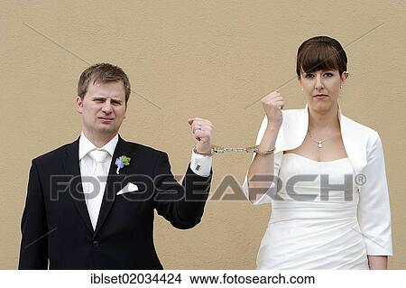 Wedding couple connected with handcuffs View Large Photo Image Picture - Wedding couple connected with handcuffs. Fotosearch